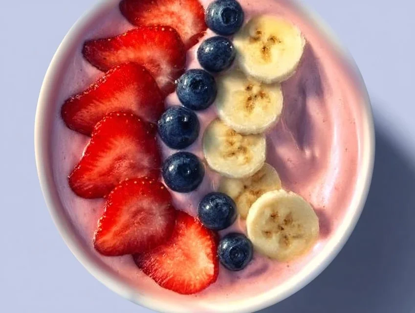A vibrant fruit smoothie bowl topped with Greek yogurt and fresh fruits