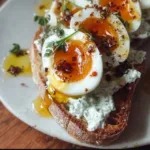 Creamy herbed yogurt served with soft-cooked eggs in a bowl.